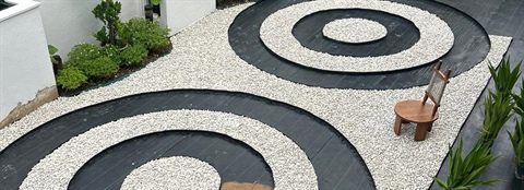 Concentric rings of pebbles in a courtyard garden